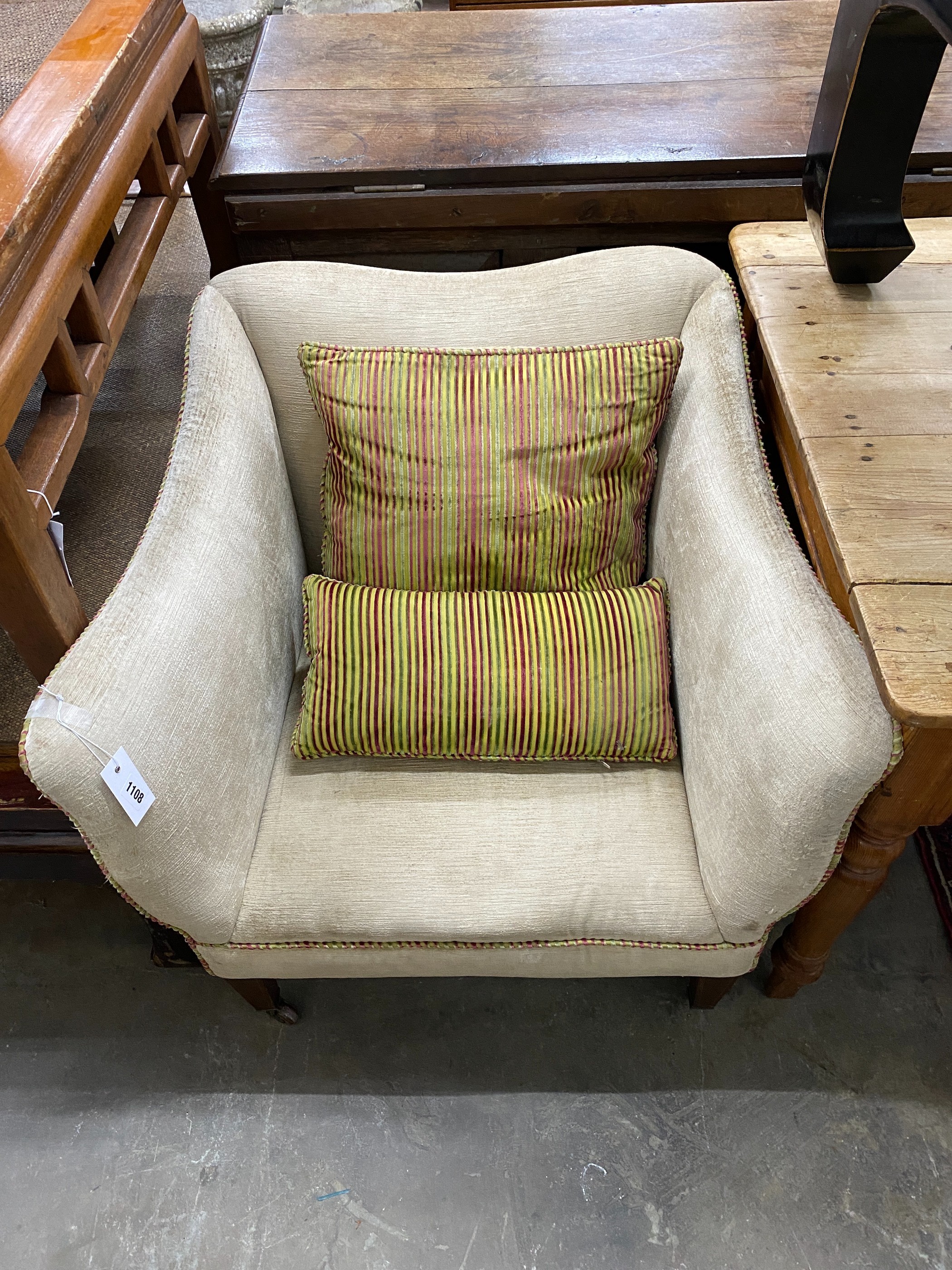 An Edwardian upholstered armchair together with a 19th century style painted footstool